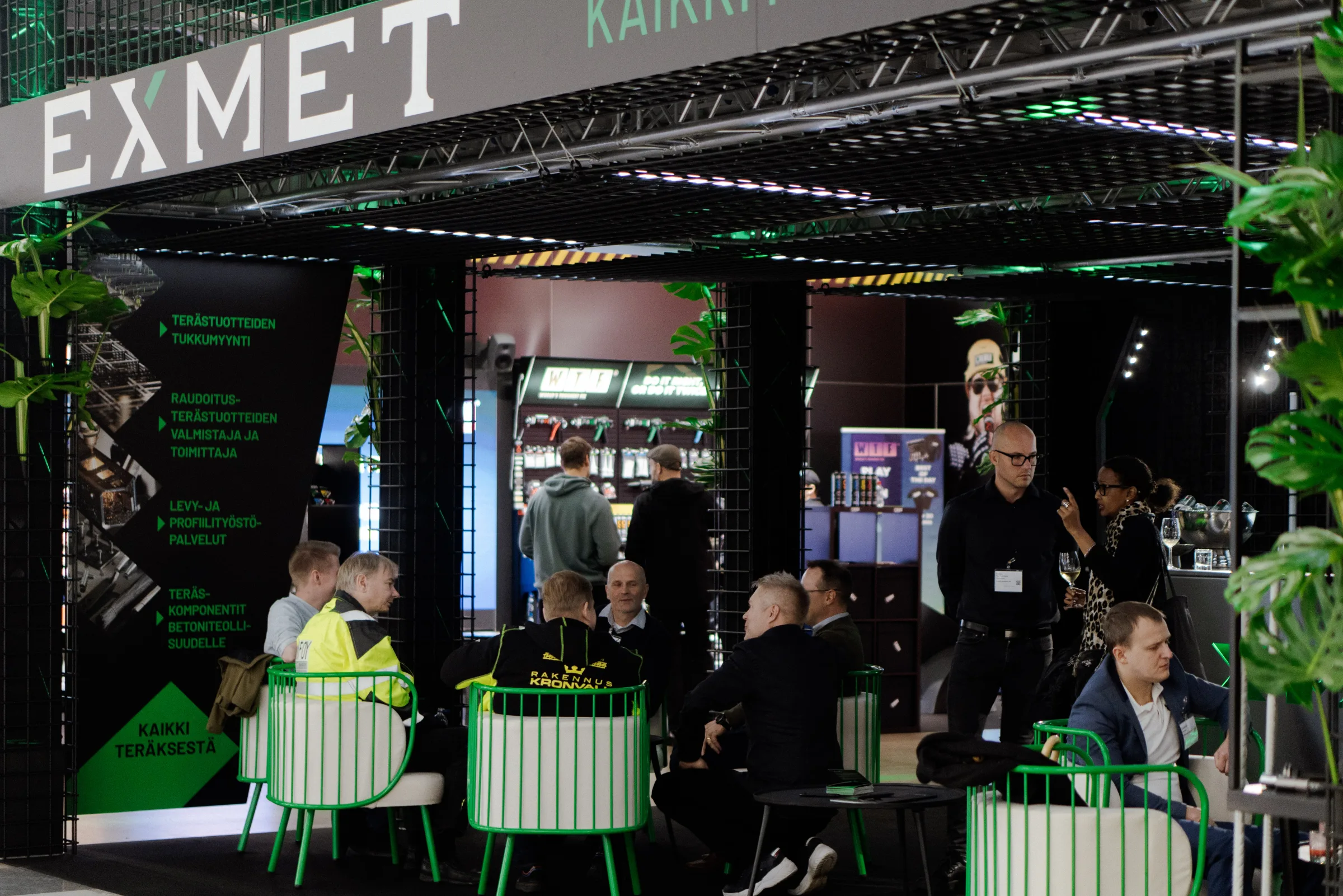 Visitors talking beside the Exmet stand