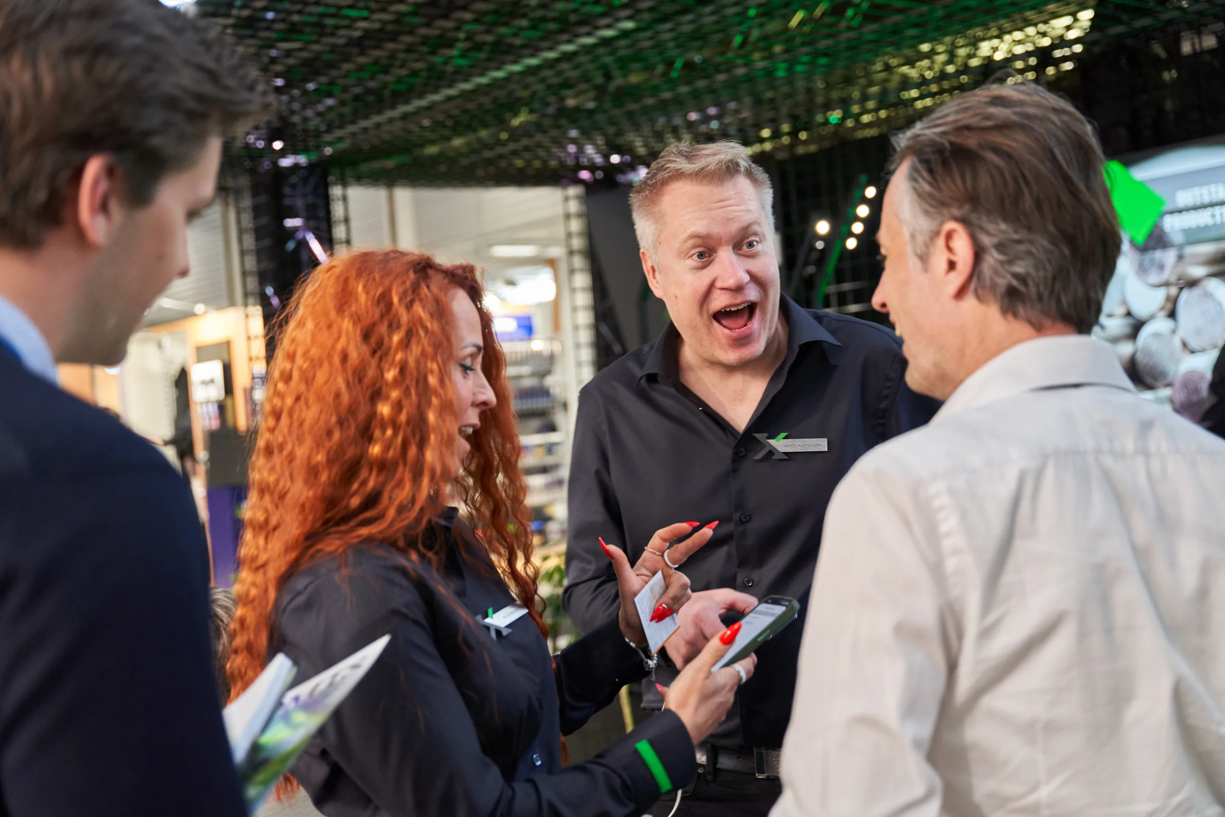 Visitors talking with the Exmet team at the stand