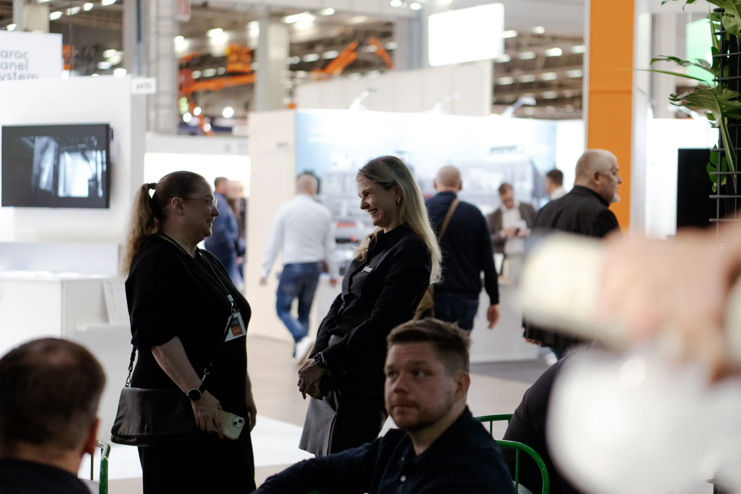 Two Exmet team members talking at the exhibition
